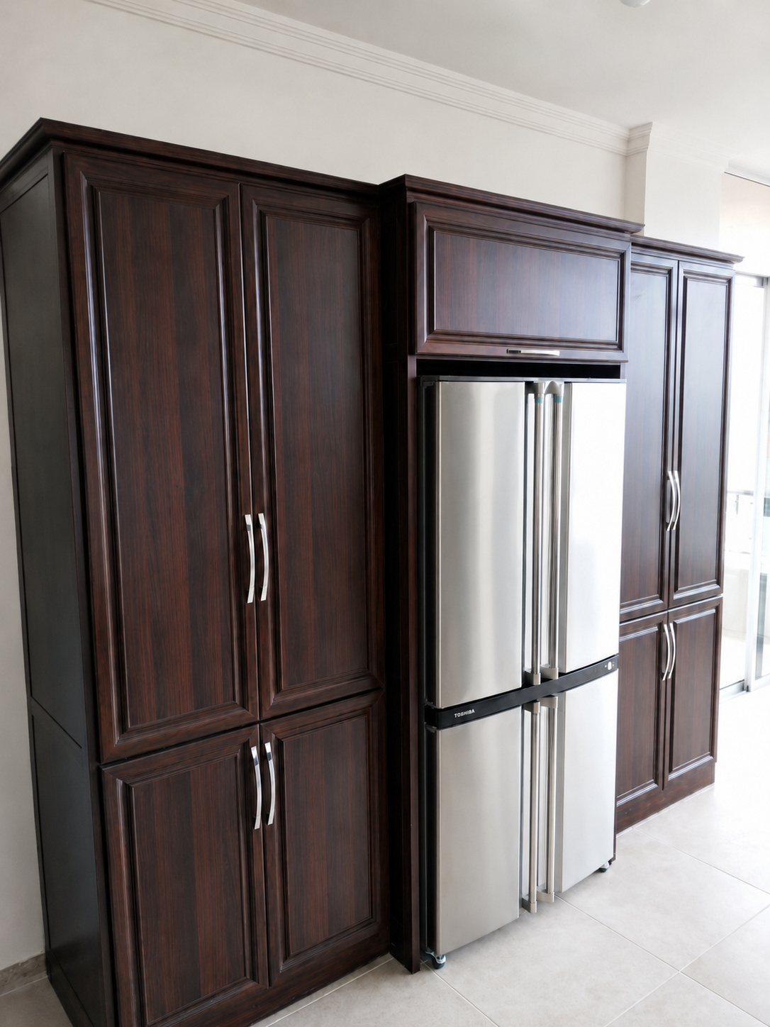 Built-in kitchen storage and pantry cabinetry.